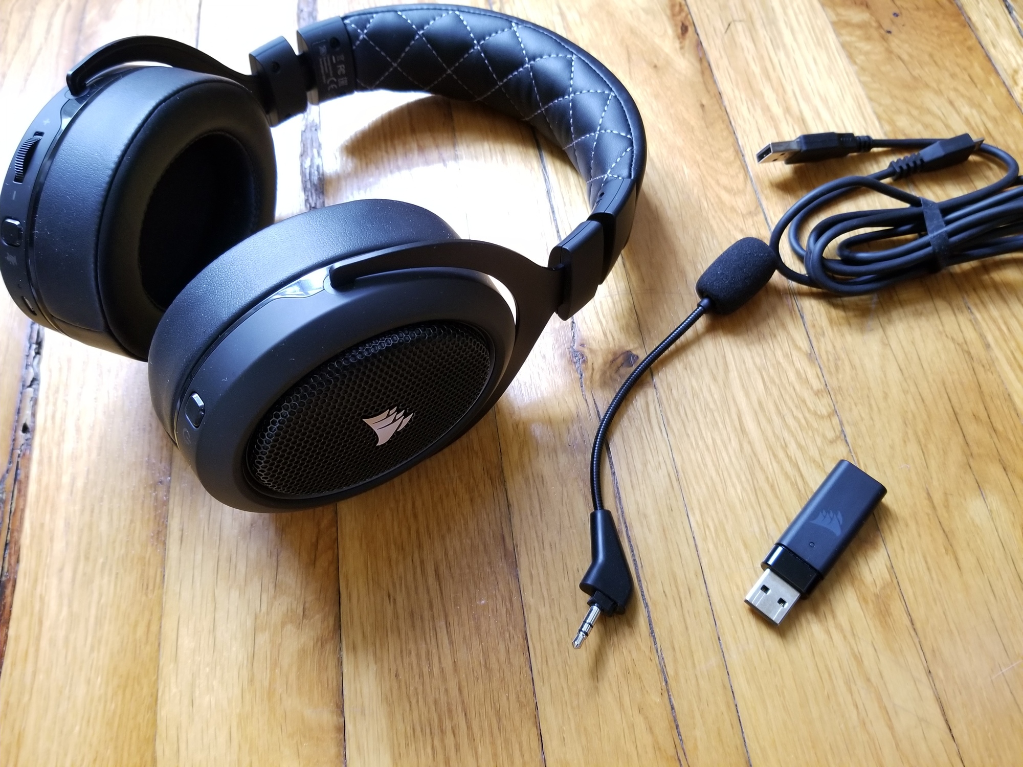 The Corsair HS70 Pro headset, with microphone, wireless adapter, and charging cable.